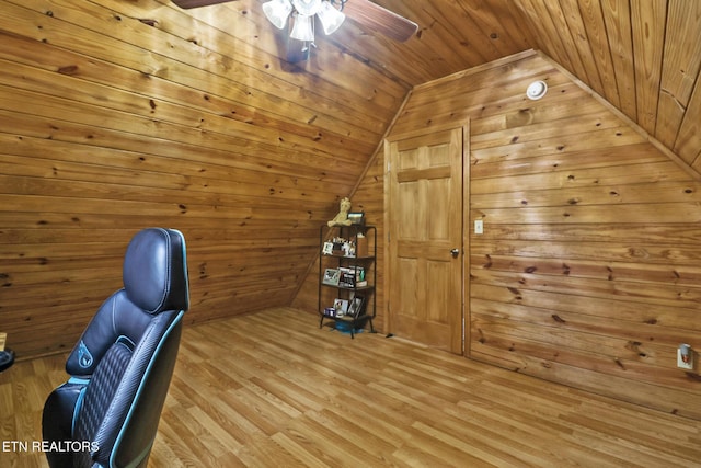 unfurnished office with lofted ceiling, wood walls, wooden ceiling, and light hardwood / wood-style flooring