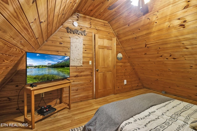 bedroom featuring wood walls, wood ceiling, lofted ceiling, and hardwood / wood-style flooring