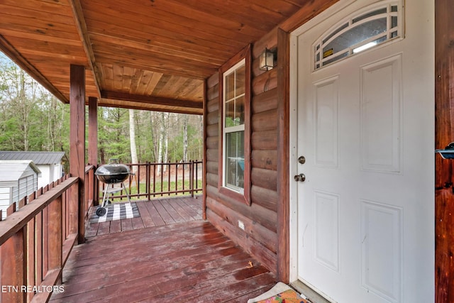 wooden deck with a grill and a porch