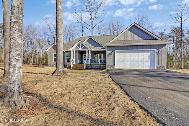 view of front of house featuring a garage and a porch