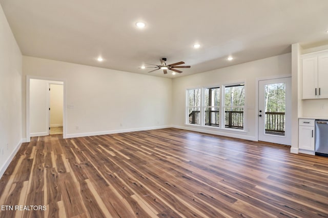 unfurnished living room featuring ceiling fan and dark hardwood / wood-style floors