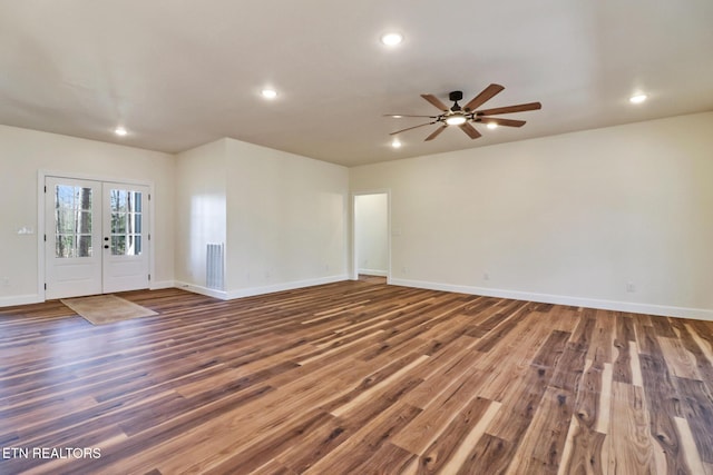 unfurnished room featuring ceiling fan, french doors, and dark hardwood / wood-style flooring