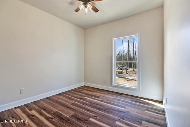 unfurnished room with ceiling fan and dark hardwood / wood-style floors