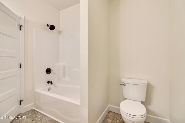 bathroom with washtub / shower combination and toilet