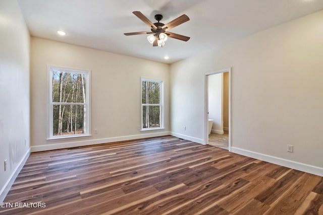 empty room with ceiling fan and dark wood-type flooring