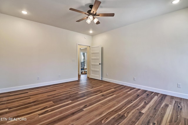 unfurnished room with ceiling fan and dark wood-type flooring