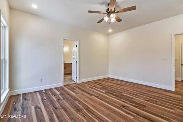 spare room featuring ceiling fan and dark hardwood / wood-style flooring