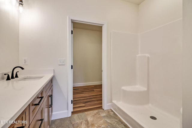 bathroom featuring a shower and vanity