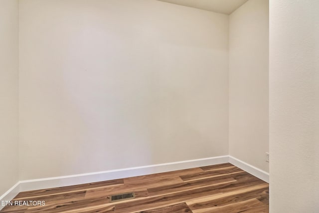 empty room featuring wood-type flooring