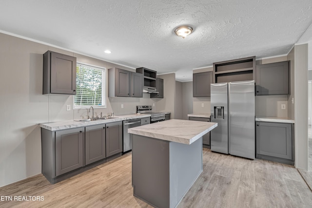 kitchen featuring gray cabinets, sink, appliances with stainless steel finishes, and light hardwood / wood-style flooring