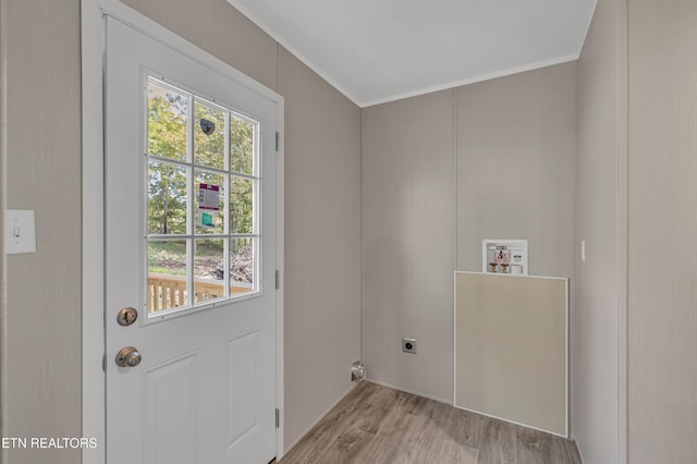 entryway featuring ornamental molding and light wood-type flooring