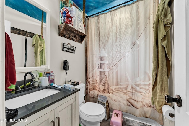 full bathroom with shower / tub combo, vanity, and toilet