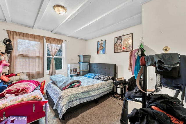 carpeted bedroom with beam ceiling