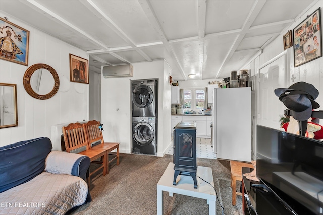 carpeted living room with wooden walls, an AC wall unit, and stacked washer and clothes dryer