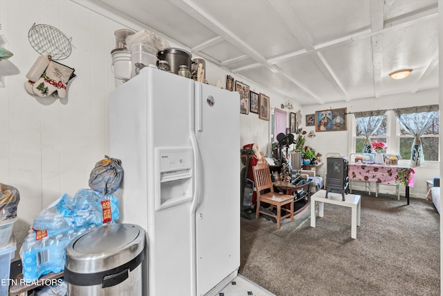 kitchen with white fridge with ice dispenser and carpet floors