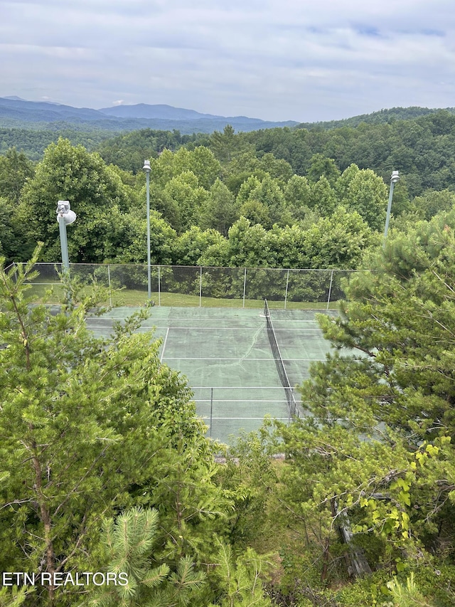 view of tennis court with a mountain view