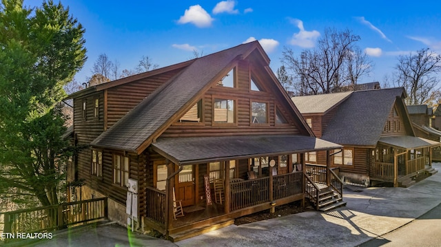 rear view of property featuring a porch