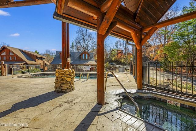 view of patio / terrace featuring a swimming pool with hot tub