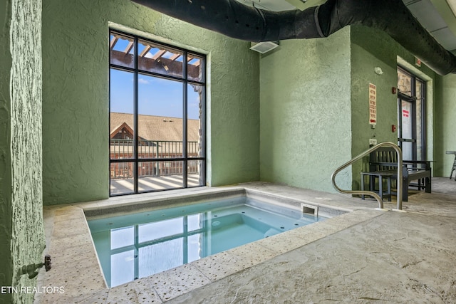 view of pool with an indoor hot tub