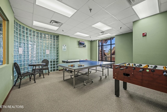 rec room with a paneled ceiling and carpet floors