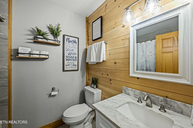 bathroom with a shower with shower curtain, a textured ceiling, vanity, toilet, and wood walls