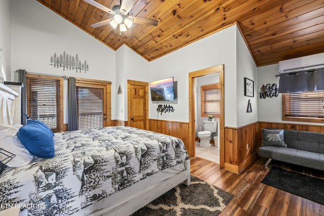 bedroom featuring a wall mounted air conditioner, dark hardwood / wood-style flooring, wood ceiling, ceiling fan, and connected bathroom