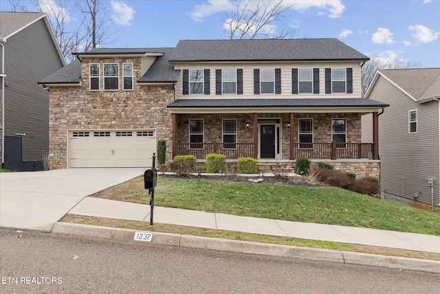 view of front of home featuring a porch, a garage, and a front lawn