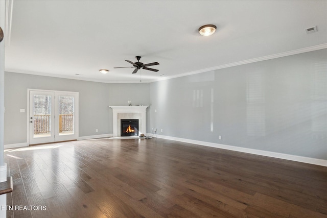 unfurnished living room with crown molding, ceiling fan, and dark wood-type flooring