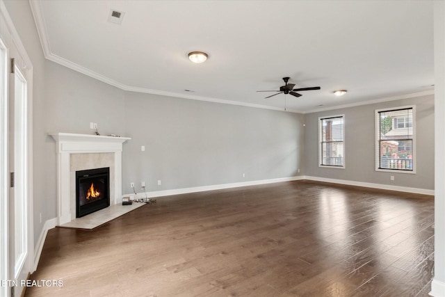 unfurnished living room featuring a fireplace, dark hardwood / wood-style floors, ceiling fan, and ornamental molding