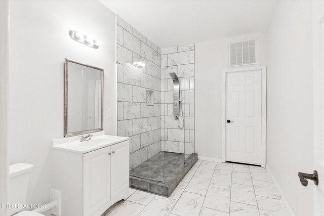 bathroom with an enclosed shower, vanity, and toilet