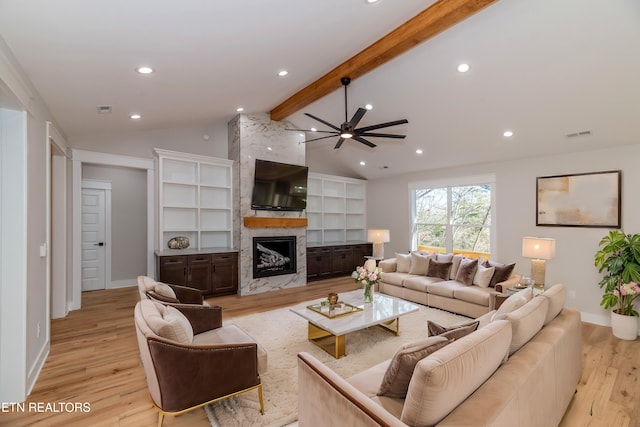 living room with visible vents, lofted ceiling with beams, light wood-style flooring, recessed lighting, and a fireplace