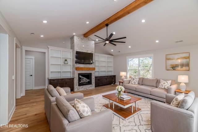 living room featuring visible vents, lofted ceiling with beams, recessed lighting, a high end fireplace, and light wood-type flooring