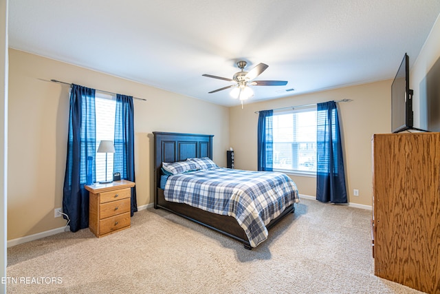 bedroom with light colored carpet and ceiling fan