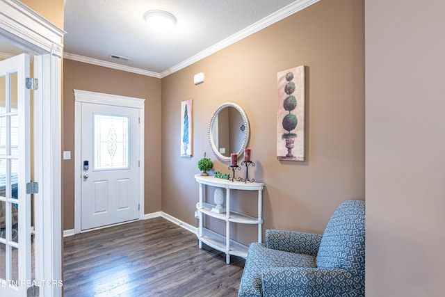 entrance foyer with a textured ceiling, dark hardwood / wood-style floors, and crown molding