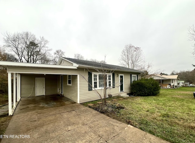 ranch-style house with a carport and a front lawn