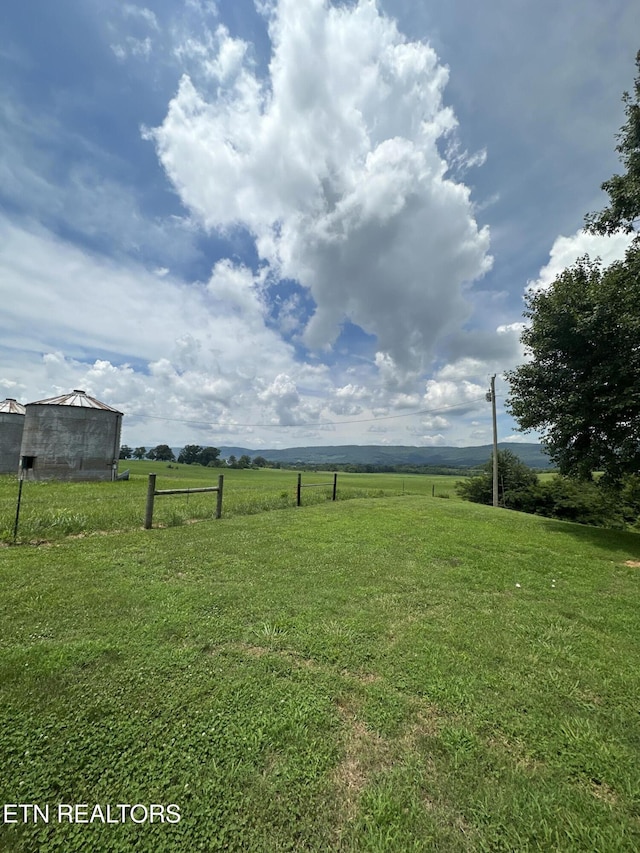 view of yard with a rural view