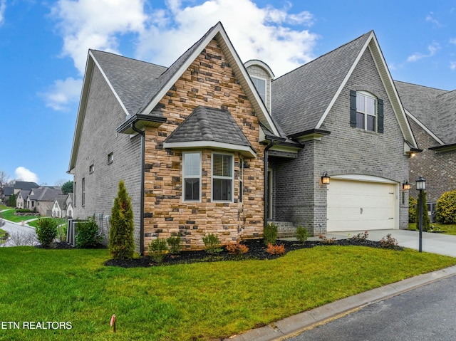 view of front of property with a garage and a front yard