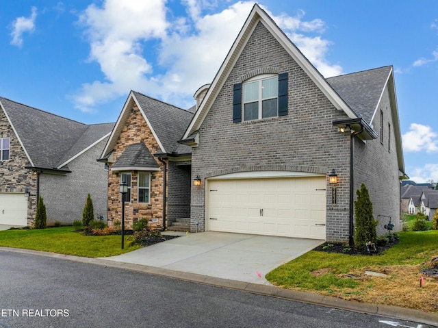 view of front facade featuring a front yard and a garage