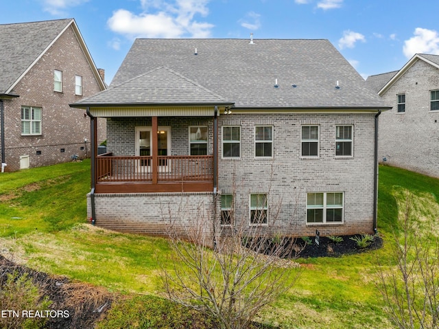 rear view of property with a lawn