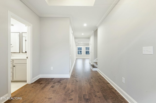 corridor featuring hardwood / wood-style flooring and crown molding