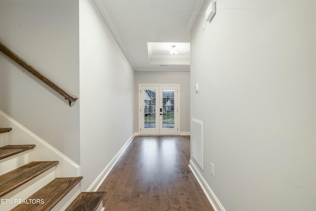 hall with crown molding, dark wood-type flooring, and french doors