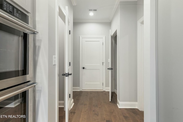 hallway with crown molding and dark hardwood / wood-style flooring