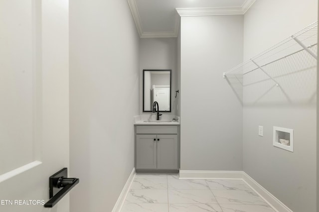 laundry room featuring sink, hookup for a washing machine, and ornamental molding