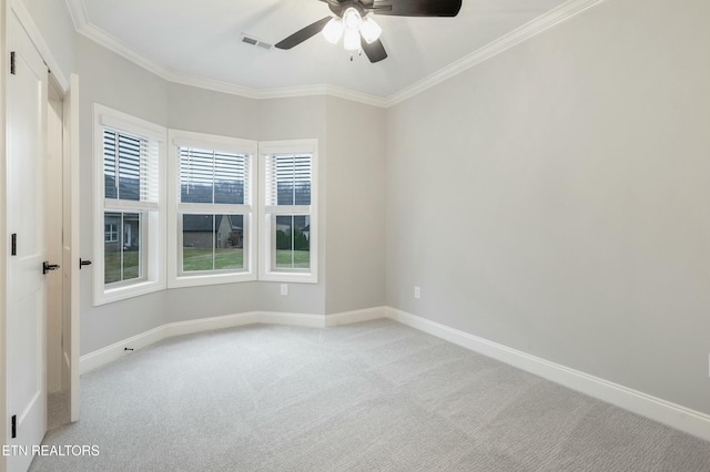 unfurnished room with crown molding, ceiling fan, and light colored carpet