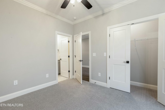 unfurnished bedroom with ceiling fan, light colored carpet, crown molding, and a closet