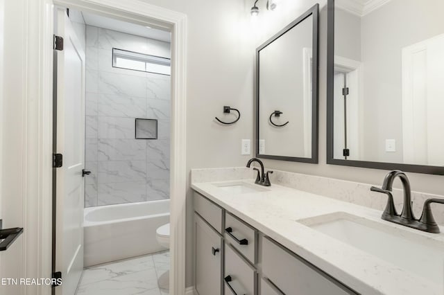 full bathroom with vanity, toilet, ornamental molding, and tiled shower / bath combo