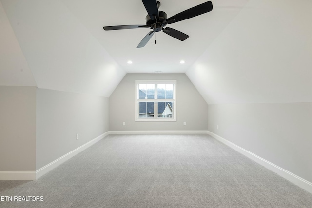 bonus room featuring ceiling fan, lofted ceiling, and light carpet