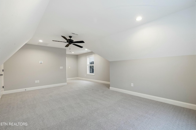 additional living space with ceiling fan, light carpet, and vaulted ceiling