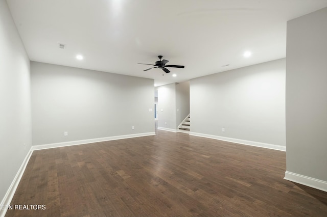 spare room featuring ceiling fan and dark wood-type flooring