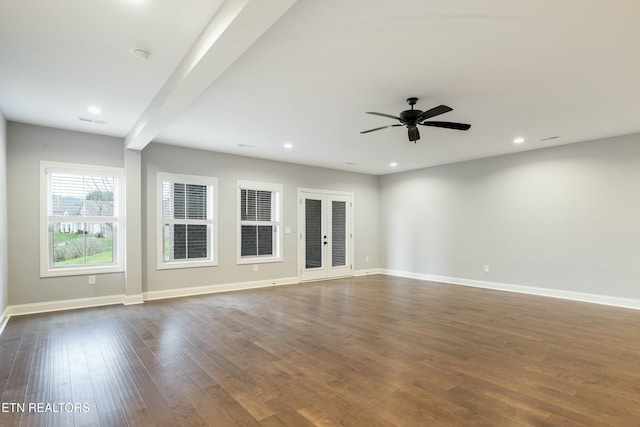 spare room with french doors, ceiling fan, dark wood-type flooring, and beam ceiling